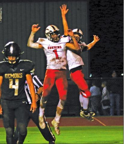 Blaze Berlowitz and Austin Munday celebrate a TD pass during the Tigers 27-7 victory over country rival Perkins-Tryon Friday. Berlowitz threw for 340 yards.
