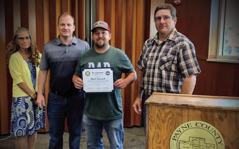 Matt Leverich receives a certificate of recognition from the Payne County Board of Commissioners for his heroic actions. Pictured from left, Commissioner Rhonda Markum, Commissioner Seth Conley, Matt Leverich, Commissioner Zach Cavett.