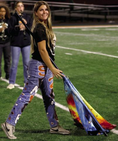 Color guard senior Mylee Risenhoover performs with the Tiger Pride during halftime.