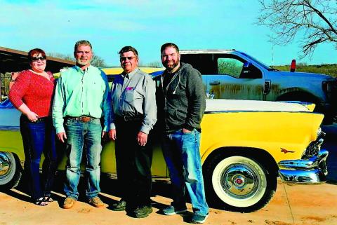 NIkki, Bret, Brad and their father Les White stand in front of the 1956 Ford Crown Victoria the kids presented to him earlier this month.