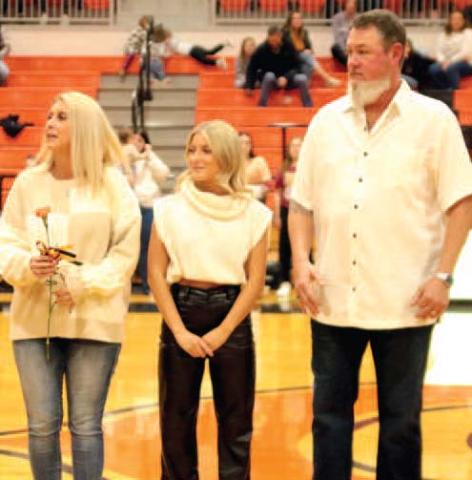 Jade Morgan escorted by her Shane and Laura Morgan.