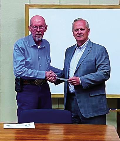 Leroy Kalka, Chairman of Cushing Regional Hospital Foundation presents a check to Mid Griffith, Chairman of Cushing Board of Commissioners, for $44,051.21 to purchase a set of orthopedic operation equipment. Dr. Hanson, orthopedic surgeon, requires two sets. In the event something goes wrong during surgery, he has a backup. Dr. Hanson is now handling several cases a week at Cushing Hospital. The City of Cushing agreed to help purchase the set.