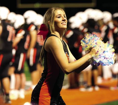 Senior Dancer Ava Babinec drums up spirit on the Tiger sidelines.