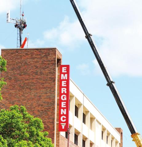 Workers install a T-Mobile tower