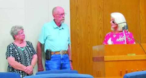Breast cancer survivor Pam Hawthorne and CHF Chairman Roy Lee Kalka listens as Commissioner Nancy Dowell, whose mother was a breast cancer survivor, accepts a donation on behalf of the CHA. The funds will go towards the purchase of a 3D mammogram machine for the hospital.