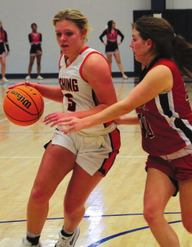 Lady Tiger Maddie Alexander dribbles past a Luther defender. Photo’s by J.D. Meisner.