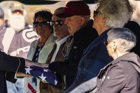 A folded American flag is presented to Robert Walker, nephew of Corporal James McKinley Walker, during graveside services Friday at the IOOF Cemetery in Maramec, honoring the Pawnee native who died as a prisoner of war during World War II and was returned home more than 80 years later. Photo by John Burns