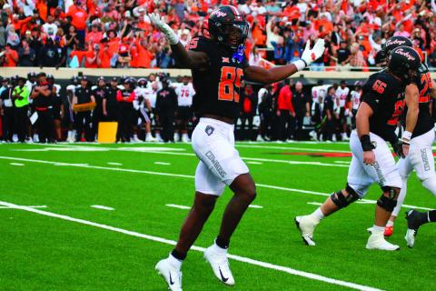 OSU’s Jaden Bray throws shrugs in celebration after a Cowboys touchdown.