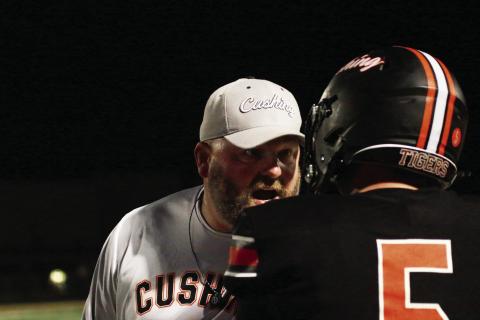 Tiger head coach Rusty Morgan leans in with a dose of hard-earned wisdom for senior Cole Cooper during Friday’s 4A football playoff clash with Hilldale. Cushing defeated Hilldale 63-34 and advanced to the second round where they will host Ardmore, this Friday, at O’Dell Field. Story, Page 8 Photo by J. D. Meisner