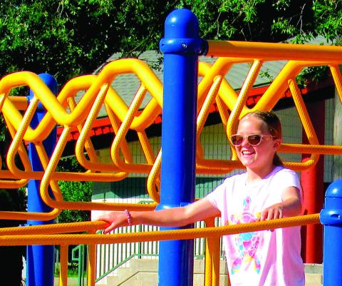 Sunshine and smiles take center stage in Memorial Park this week, as Dusti Hoover explored the playground. More sun and fun images inside. Photo by Deanna Maddox