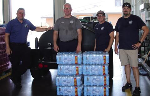Cushing Emergency Management Director Franklin Reed, Cushing Fire Captain Justin Mincer, Cushing Fire Corporal Justin Ward, and Cushing Fire Chief Dalton Novotny stand in the fire station-turned water distribution center last week. Photo by Allie Prater