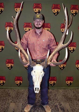 Zane Scrivner holds the antlers of the elk he took in September at Fort Sill. It is Oklahoma’s new record nontypical elk with a score of 411 1/8. (Photo by Don P. Brown/ODWC)