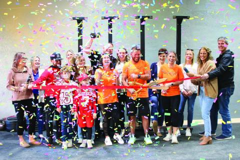 Tyler Ashbaugh, owner of Cushing CrossFit cuts the red ribbon for the grand opening of his new CrossFit gym in downtown Cushing, Friday Nov. 10. Cushing CrossFit is located at 114 W Broadway with classes available from 5 a.m. to 6 p.m. Photo by Allie Prater