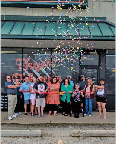 New owners of Tiger Nutrition and Tiger Fitness cut the ribbon during the reopening ceremony hosted by Cushing Chamber of Commerce members.