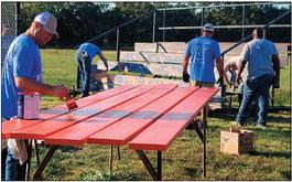 Enbridge employees painting bleachers at Yale Elementary School.