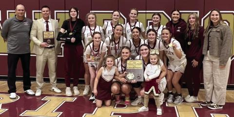 The Ripley Lady Warriors stand with their first place plaque after winning the Ripley tournament last week. The Lady Warriors beat Glencoe 41-14, Crossings Christian 54-17, and Prague 46-38.