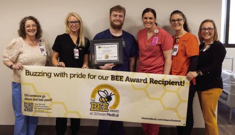 From left: Mary Beth Hunziker, Kelsey Hancock, award recipient Russell Goodgion, Alexis Gribbon, Chelsea Engle, and Deborah Aguilar, all members of the BEE committee.