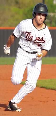 Brody Robinson turns and burns toward third base Monday against the Glenpool Warriors.