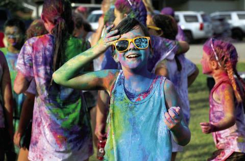 Julz O’Kelley brushes the hair off her prismatic face after the “color explosion” at the 2024 Do or Dye color run hosted by the Geographic Club of Cushing Saturday, Aug. 17. Photo by Allie Prater. See page 6 for more color run photos.