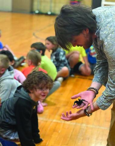 Cushing Elementary student Griffin Moore is awestruck by a spider that was brought out during the event for the BUGG Club recently.