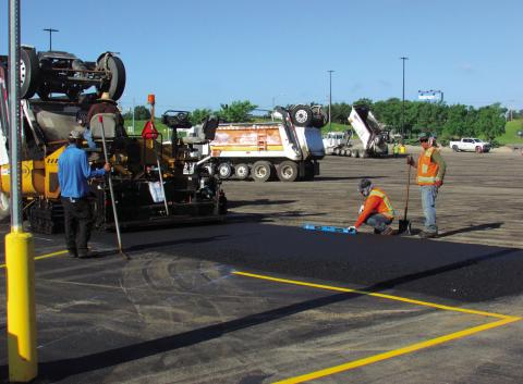 Crews were out at Cushing Wal-Mart on June 26 repaving a section of the parking lot to improve the surface to give locals a smooth ride to pick up their pre-holiday supplies. The project included a layer of fresh asphalt and new striping to enhance safety and traffic flow. Photo by DeAnna Maddox.