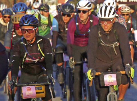 Laiken and Chris Holzer, of Perkins, make their way through the start line crowd at the start of the 100 mile Mid-South Gravel race Saturday, March 16. Photo by Allie Prater.