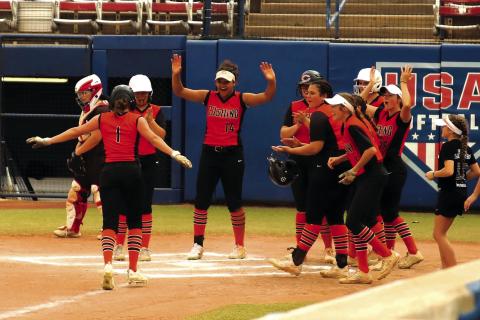 The Cushing Lady Tiger softball team celebrates as they greet freshman Matti Terrell at the plate after she blasted a solo home run over the centerfield fence of the stadium field at Devon Park, formerly known as the USA Softball Hall of Fame in Oklahoma City Friday. The Lady Tigers went on to defeat the Locust Grove Lady Pirates 11-3. The Lady Tigers are sitting on an 8-1 record and are ranked as the No. 8 team in Class 5A. See story Page 5. Photo by Rebecca Withiam.