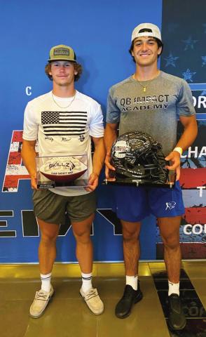 Camden Crooks and Blaze Berlowitz hold their MVP trophies at the QB Impact Academy football camp held at AT&amp;T Stadium in Arlignton, Texas.