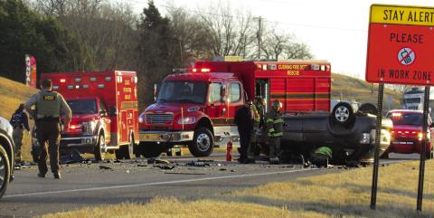 Members of the Cushing Fire Department and the Payne County Sheriff’s Department work the scene of a triple fatality just west of Cushing on SH 33 last week.