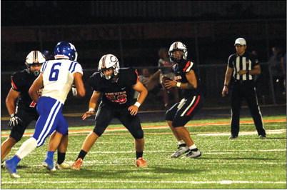 Quarterback John Hilligos looks for an open receiver. He threw for 290 yards last week and three TDs.