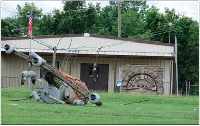 A fallen power line pole lays in front on the senior center in Agra. Photo by DeAnna Maddox.