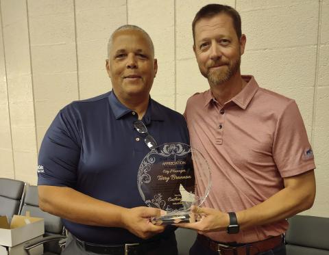 Left: Left: Freshly retired city manager Terry Brannon stands with interim city manager Derek Griffith during Brannon’s retirement party Friday, June 28.