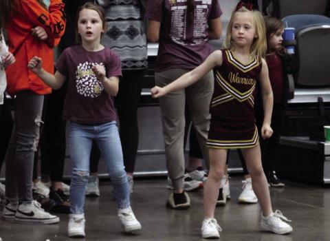 Ellis Billingslea (left), and Lainey Pitts (right), cheer on the Warriors in their 40-34 victory over OBA in the Area semi-final.