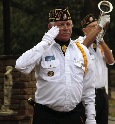 Legionnaire GW Davis salutes as Robert “Chef” Howell plays taps during the flag retirement ceremony at the Donaldson/ Walker Cushing-Drumright American Legion Post 108 Oct. 25. Photo by Allie Prater
