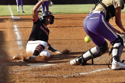 Freshman Macie Townes slides into home. Townes went three for three in the batters box against Davenport, scored one run and had three RBIs. Photos by Sarah Townes