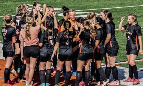 The Cushing Lady Tigers Soccer team huddle before their match against Casady on Tuesday, April 2. Photo by Sarah Townes.