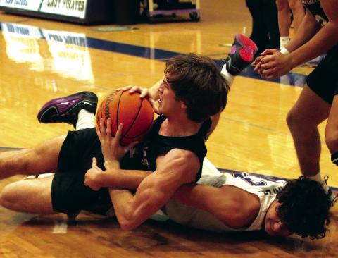 Max Wood goes to the hardwood in a battle for possession. Photos by J. D. Meisner