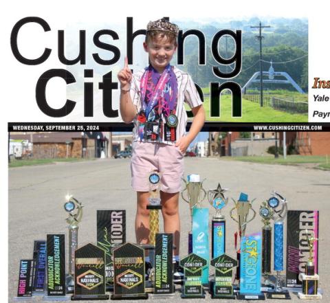 Connor Cline shows off his hardware in downtown Cushing. Photo by Allie Prater.