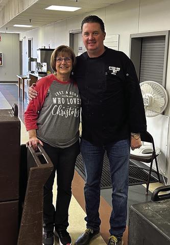Debbie Brown, director of the Senior Citizen Center, stands with Jason Kinsey of Steer Inn Cushing after Kinsey donated and delivered a Christmas feast for local seniors. The meal included barbecue pulled pork, mashed potatoes and gravy, green beans, rolls and apple cobbler, serving 81 seniors at the center and providing 30 meals to homebound residents.