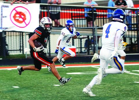 Lane Simpson sizes up the defense on his way to the end zone to score Cushing’s first touchdown of the night Friday. Photo by J. D. Meisner