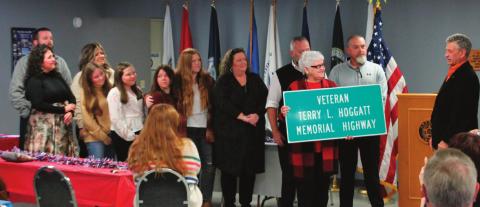 Representative Talley presents a ceremonial road sign dedication to the multitude of family members of Terry Hoggatt during the dedication held at the American Legion Post 108 on Nov. 11.