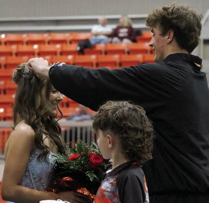 King Bryce Ward crowns Queen Laramie McCoy as crown bearer Easton Wright watches on. Photo by Allie Prater