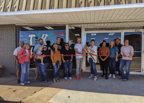 Chamber of Commerce members attended the ribbon cutting ceremony for Tiki Hut located at 221 North Cleveland Avenue, on Friday, Oct. 14. Pictured from left are John Rhoten, Tanya Rhoten, Geoff Beasley, Shawnee Ralston holding Lilah Beasley, Dana Cramer, Brandon Wolff, Tera Shooley, Tiki Hut Co-Owner Brian Demark hold the scissors with Owner Naveah Taylor-Tennison standing to the left of Co-Owner Carol Medford, Chamber President/CEO Tracy Caulfield, John Moran, and Sarah Townes. Photo by Afton Pierce.