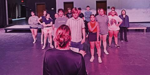 Emily Moore offers direction to cast members of the upcoming performance of “Footloose” the musical during a recent rehearsal to prepare for the spring production.