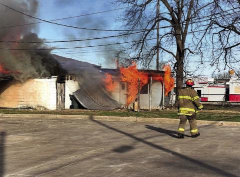 Cushing Fire Captain Tyler Morris, among the first to arrive at the scene, takes an assessment to help plan his department’s attack strategy. Photo by J. D. Meisner
