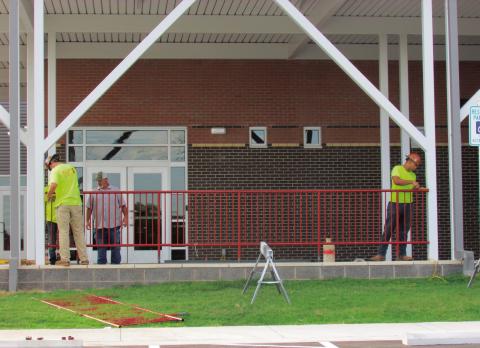 Crewmembers from Allied Steel install railings and make last-minute touches to the new Cushing Elementary School last week. The building was deemed ready for students for the opening of school on Aug. 13 school began on August 13 this week.