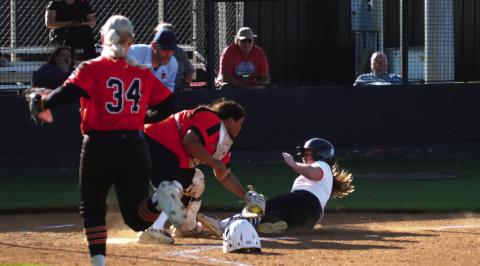 Lady Tiger courtesy runner Zoie Ledgerwood shows no fear as she slides (almost) into home Thursday. Photo by J. D. Meisner