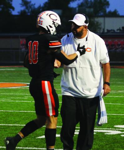 Offensive Coordinator Scott Chisholm congratulates wide receiver Brock Bales after he scored Cushing’s first touchdown of the night Friday.