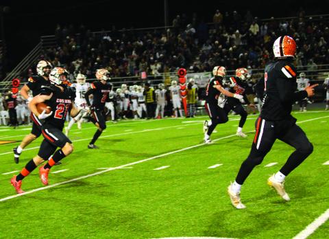 Camden Crooks, flanked by a host of Tiger blockers returns a punt to score Cushing’s fifth touchdown against the Elk City Elk.