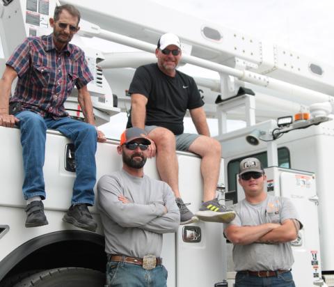 Dub Hargrove and his son Joe, and Doug Biswell and his son Taegan work together at the City of Cushing’s Electric Distribution Department. Photo by J. D. Meisner
